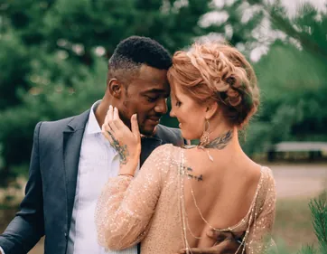 A couple sharing a close moment in a garden